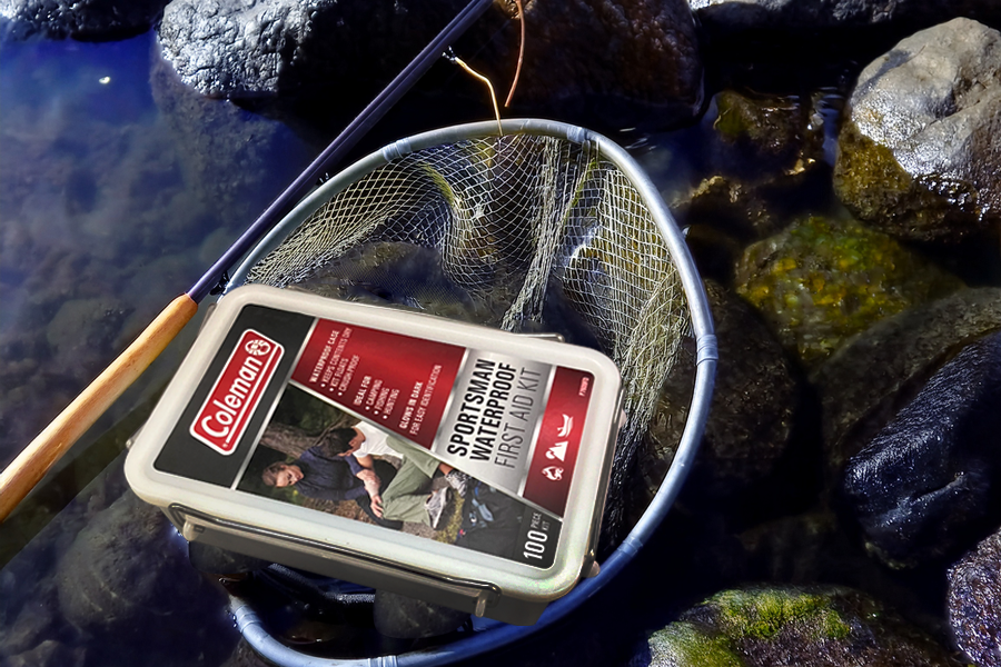 Coleman Sportsman Waterproof First Aid Kit - 100 Pieces pictured in a fishing net in a pile of fishing supplies