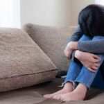 depressed woman on couch