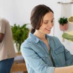 woman and man potting indoor plants