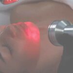 woman receiving red light therapy in spa
